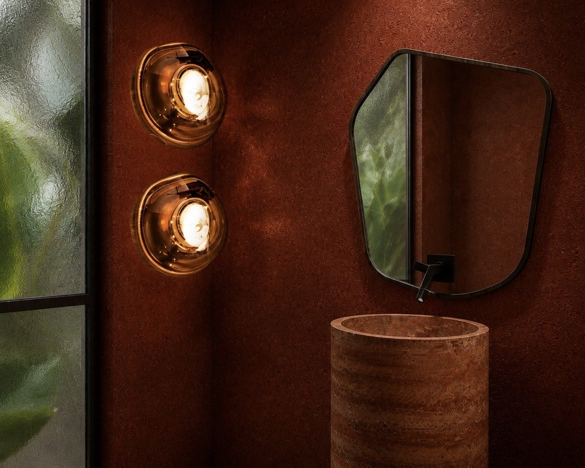 Copper-toned studio bathroom, sink and round mirror